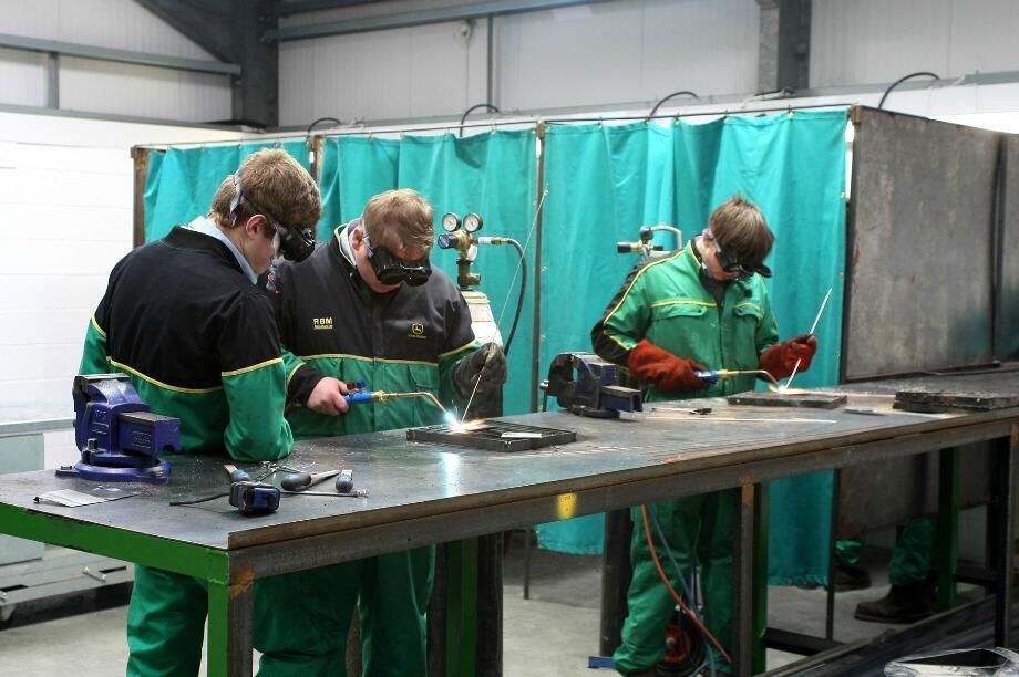 Apprentices welding at a bench during a practical session